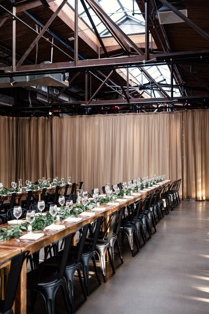 A long wooden table set for wedding reception at Ovation Chicago