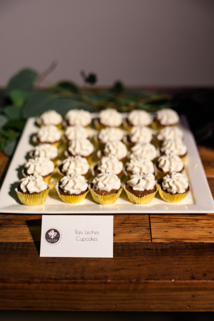 A tray of tres leches cupcakes topped with white frosting for wedding reception at Ovation Chicago