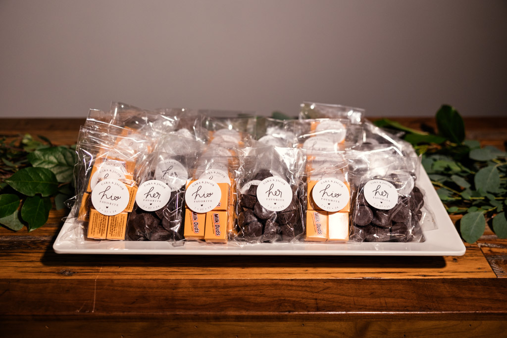 Assorted chocolate treats wrapped in clear plastic bags for Ovation Chicago wedding reception
