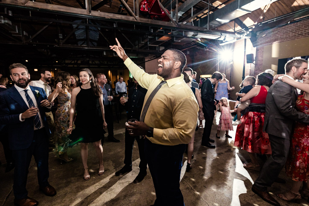 Man in a yellow shirt on the dance floor during Ovation Chicago wedding reception