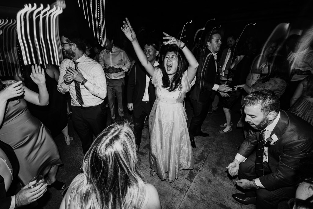 Black and white photo of dancing guests during wedding reception at Ovation Chicago