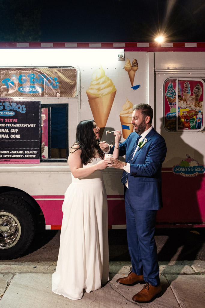 Bride and groom enjoy ice cream from the Big Bro's truck during their Ovation Chicago wedding reception