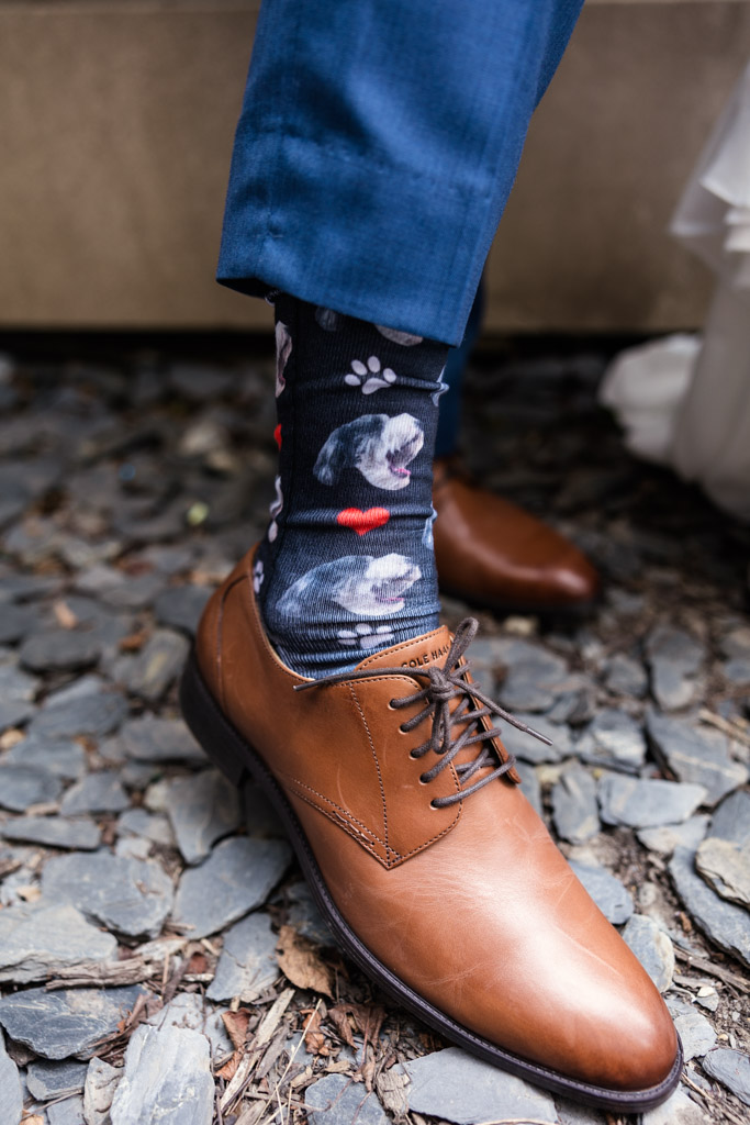 Groom's custom dog-themed socks and brown leather shoes