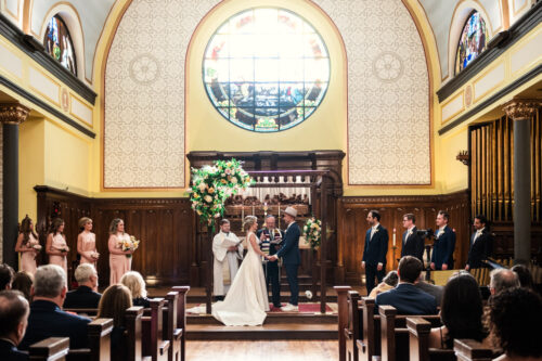 Bride and groom hold hands during their wedding ceremony at Wicker Park Lutheran Church in Chicago