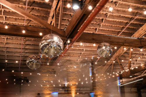 Walden Chicago's wooden ceiling adorned with string lights and silver disco balls
