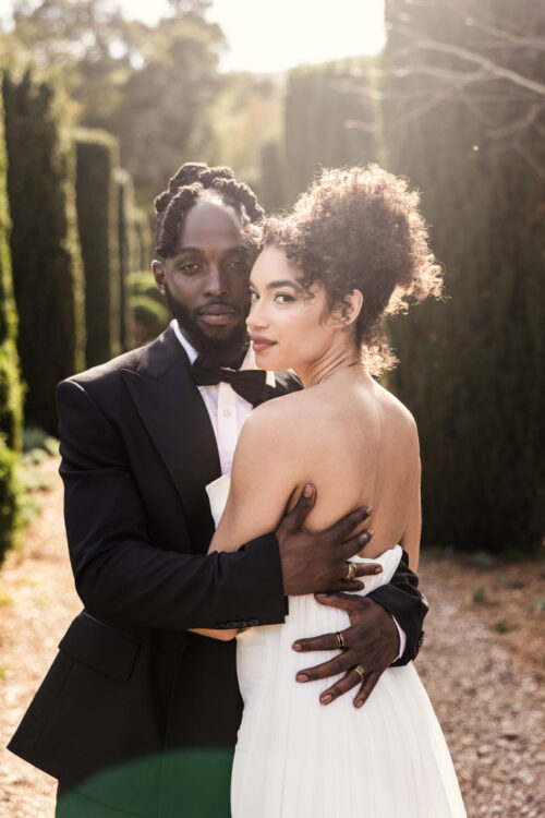 Bride and groom in wedding attire embraces outdoors at Filoli Historic House & Gardens