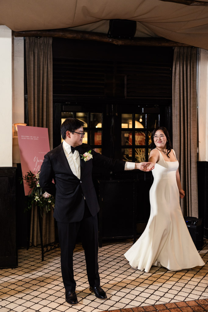 Bride and groom dance in reception space at Osteria Via Stato during their Chicago winter wedding celebration