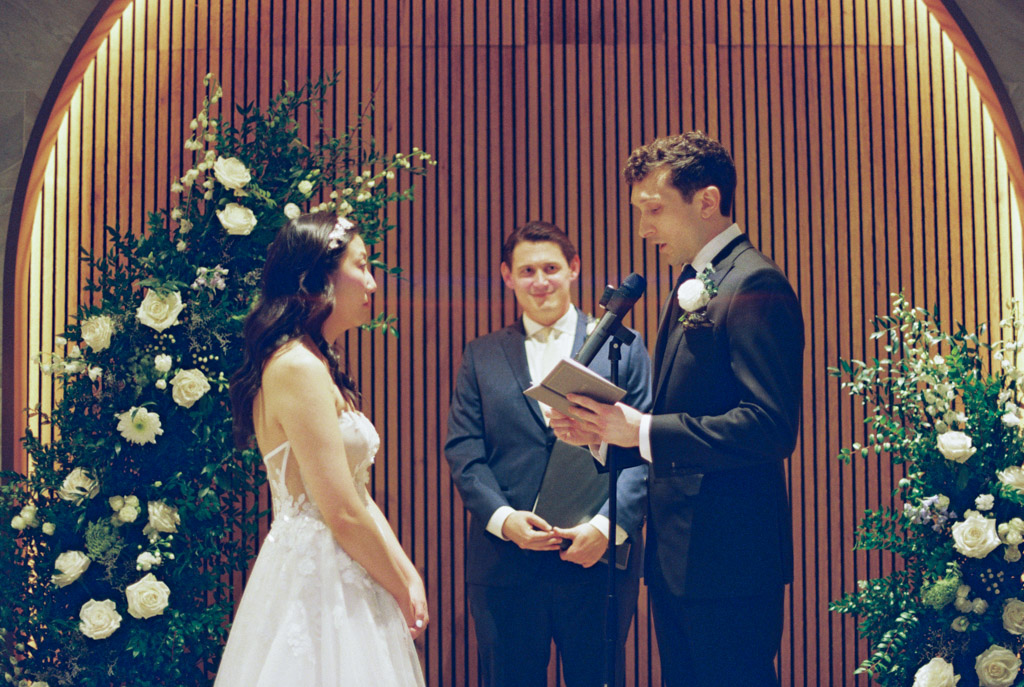 Film photo of groom reciting his vows during wedding ceremony at Chicago Winery