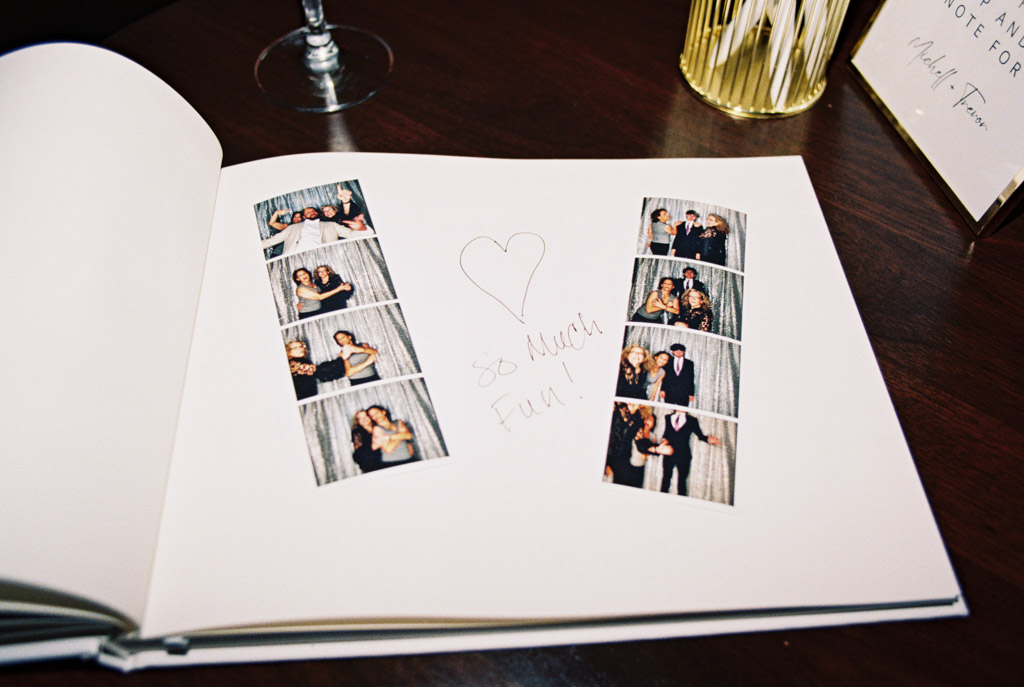 Open guestbook with two photo strips and a handwritten message for Chicago Winery wedding reception