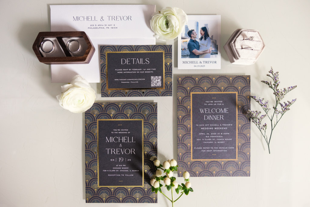 Flat lay of wedding invitations and stationery with floral accents and rings for Chicago Winery wedding celebration