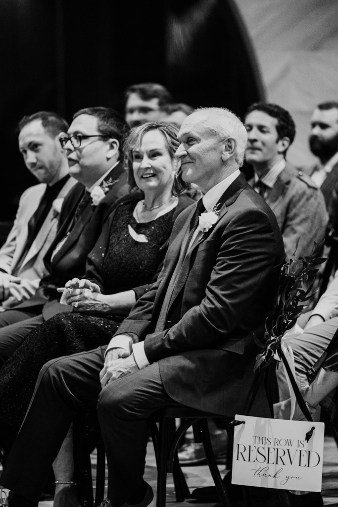 Black and white photo of groom's parents during wedding ceremony at Chicago Winery