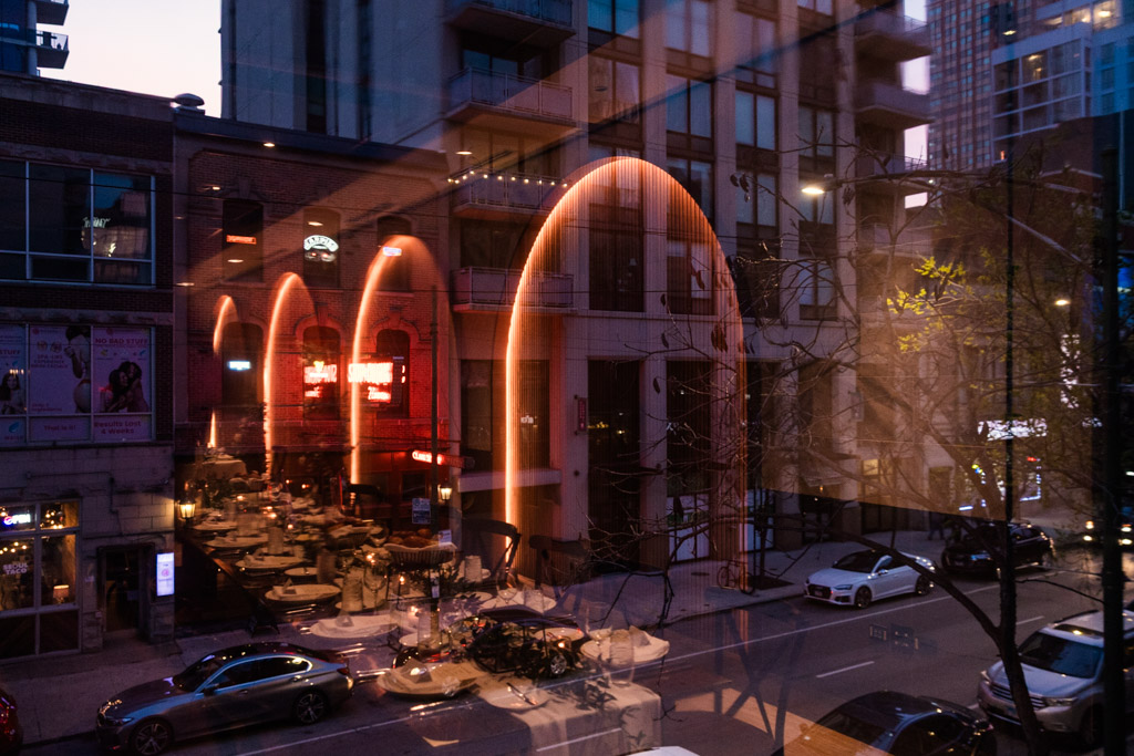 Creative photo of downotwn Chicago street view at dusk with reflections of Chicago Winery reception space