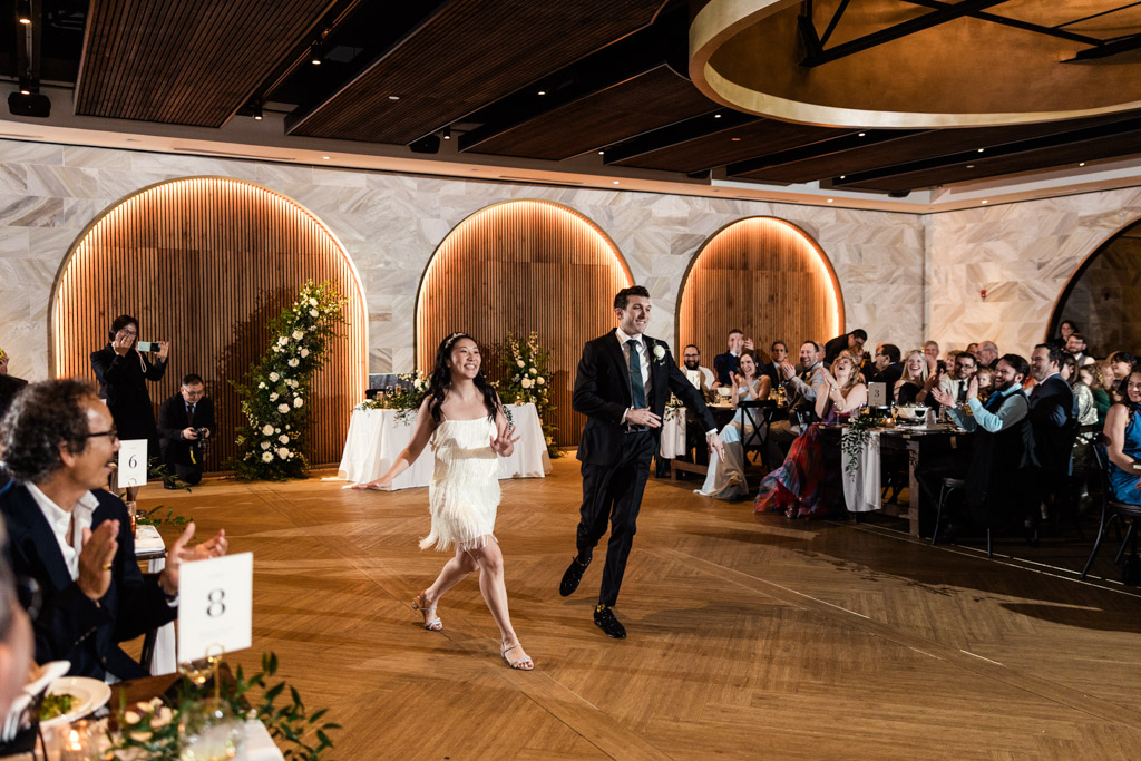 Newlywed couple during their first dance at their Chicago Winery wedding reception as guests cheer and applaud