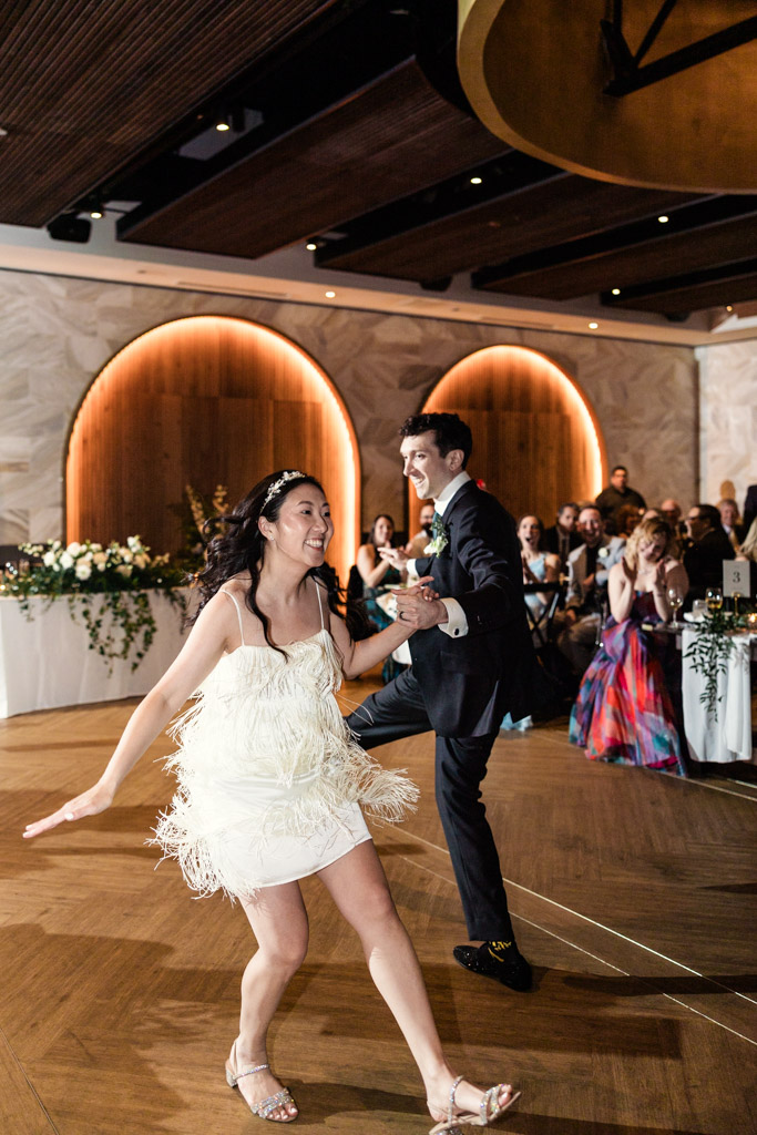 Bride and groom joyfully dance during their wedding reception at Chicago Winery