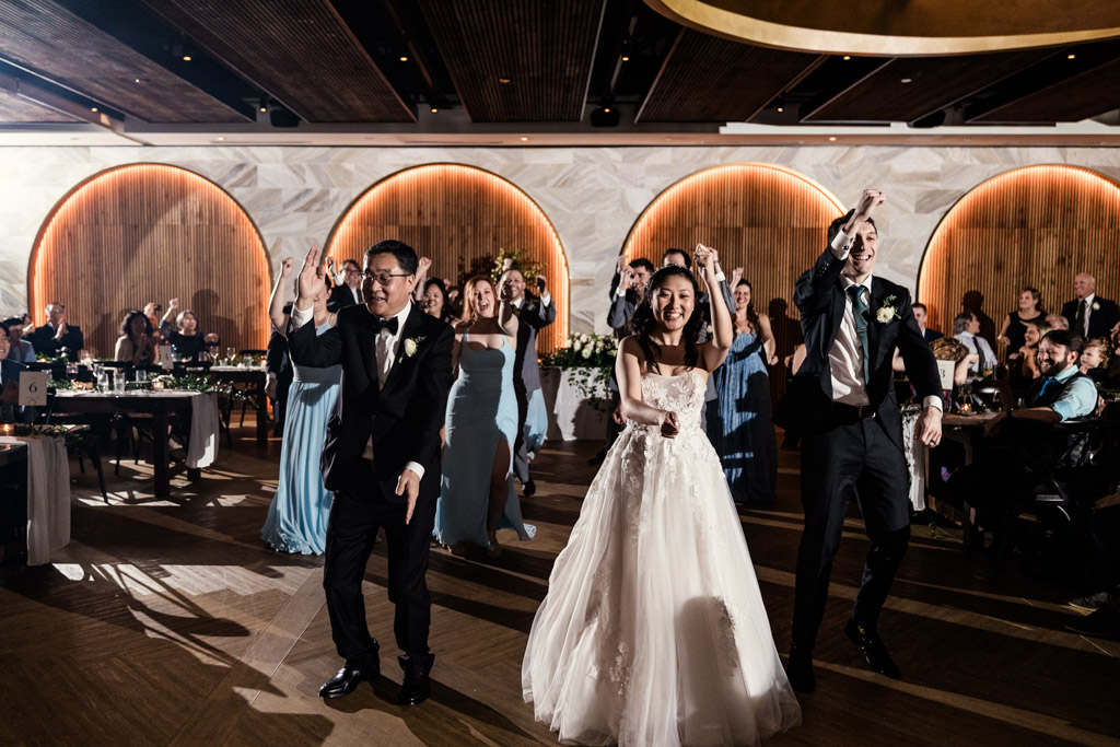 Bride, groom and guests perform a coordinated dance during wedding reception at Chicago Winery