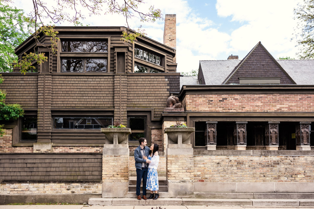 Couple stands together in front of the Frank Lloyd Wright Home and Studio during their Oak Park engagement session