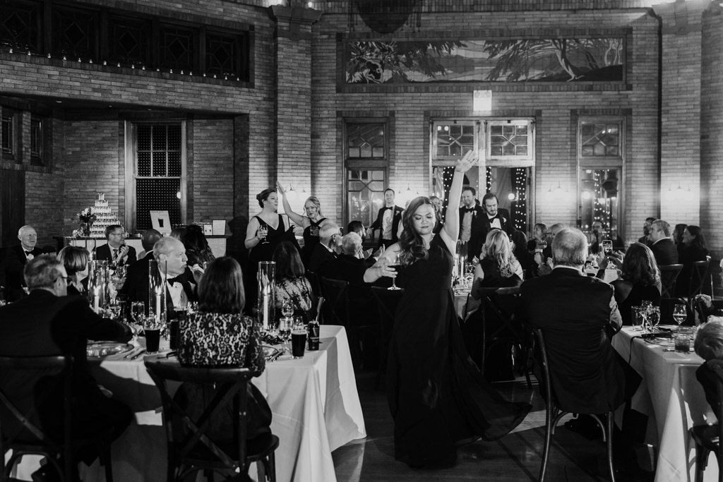 Black and white photo of bridesmaid dancing during Cafe Brauer wedding reception