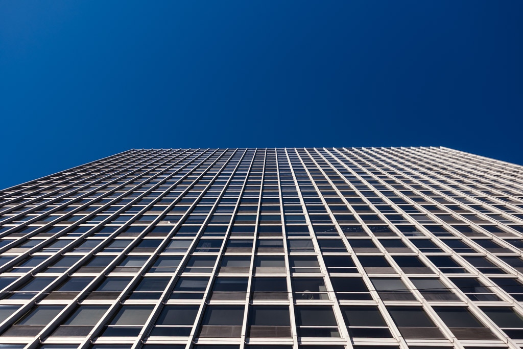 Exterior of bride and groom's apartment building under a clear blue sky