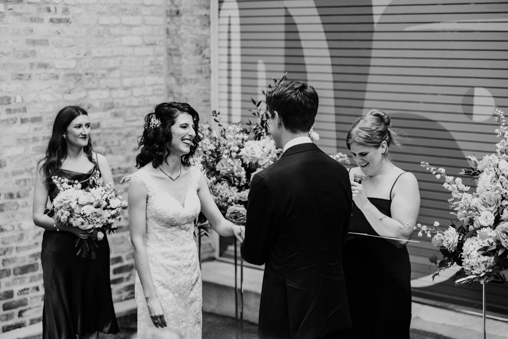 Black and white of bride and groom exchanging vows at their Ada Street Chicago wedding ceremony