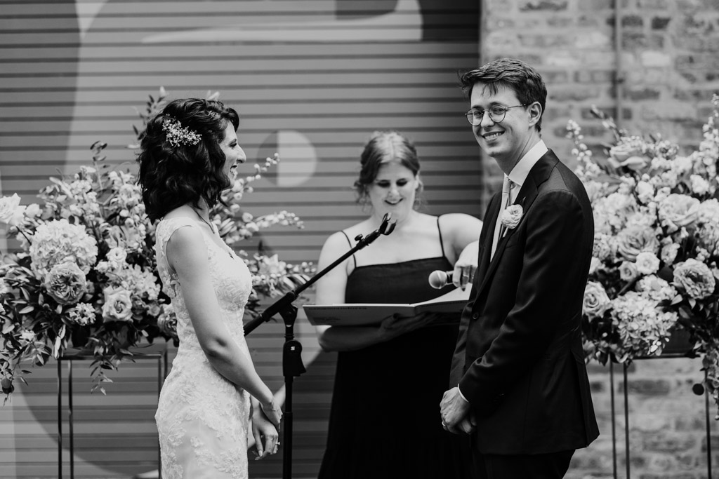 Black and white photo of bride and groom during their wedding ceremony on Ada Street Chicago