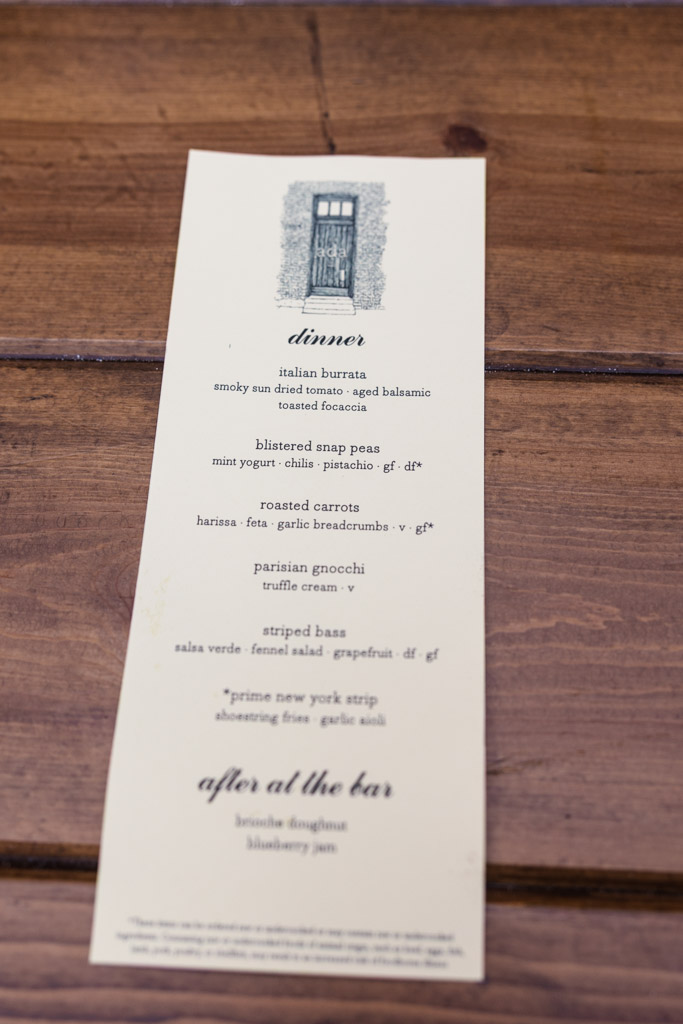 Dinner menu for Ada Street Chicago wedding reception on a wooden table