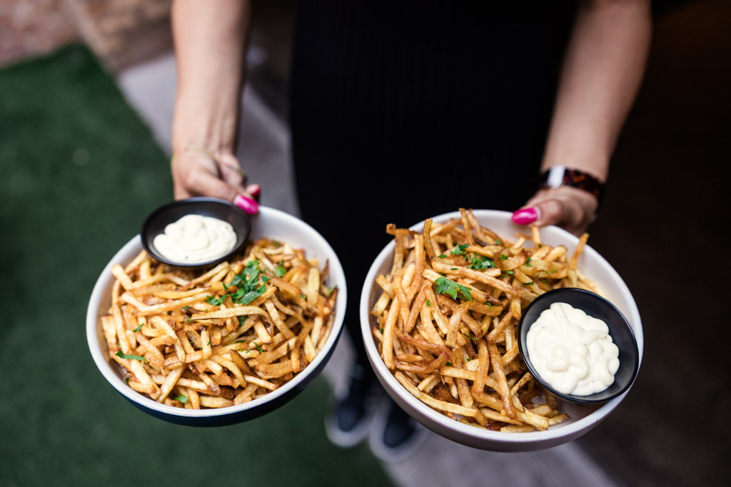 Bowls of crispy fries with parsley, each served with a small dish of mayonnaise for wedding reception at Ada Street Chicago