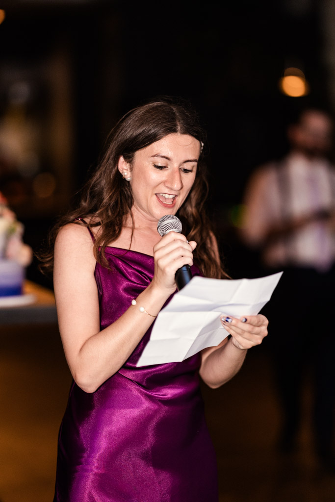 Maid of Honor in a purple dress gives speech during wedding reception at Ada Street Chicago