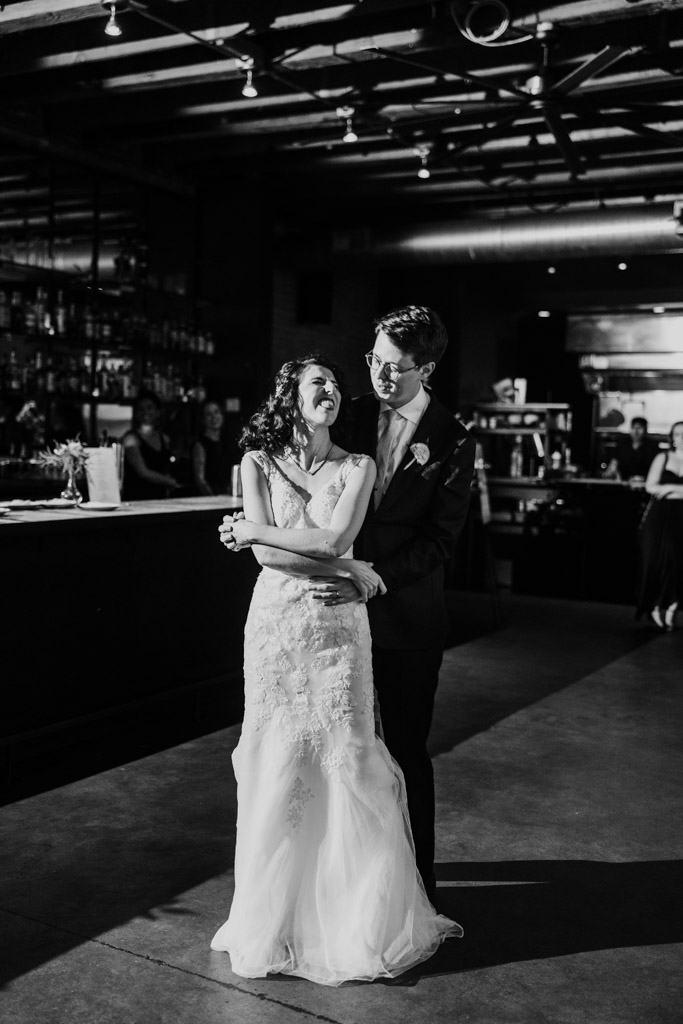 Black and white photo of newlyweds dancing inside Ada Street Chicago