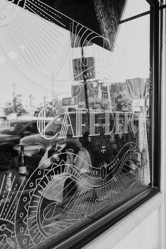 Black and white photo of Cafe Deko front window with Art Deco decoration