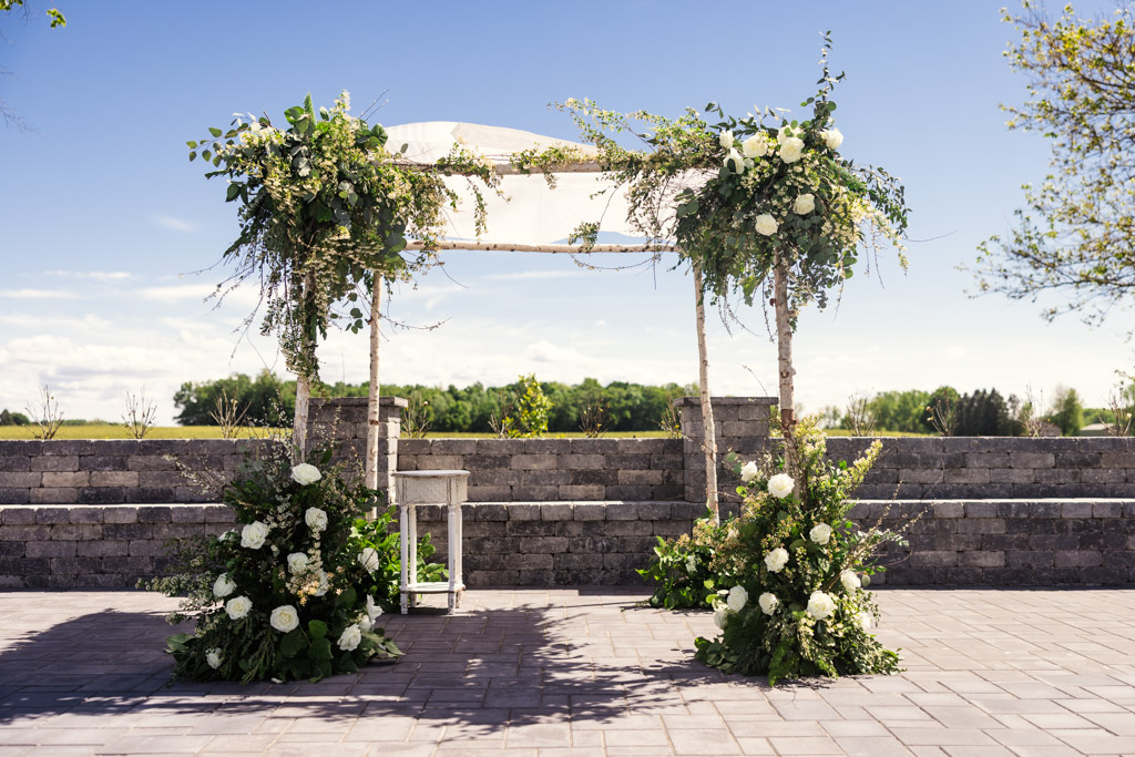 Custom chuppah with white flowers and greenery for Être Farms wedding ceremony