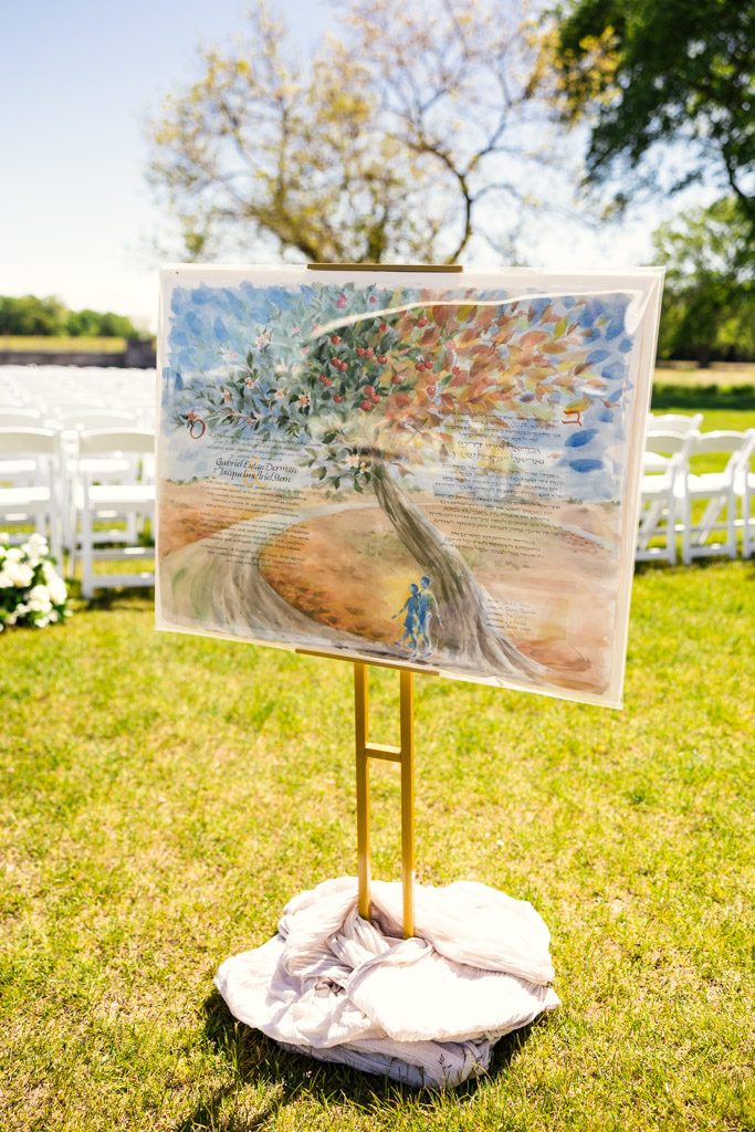 Bride and groom's ketubah on display in the outdoor wedding ceremony space at Être Farms