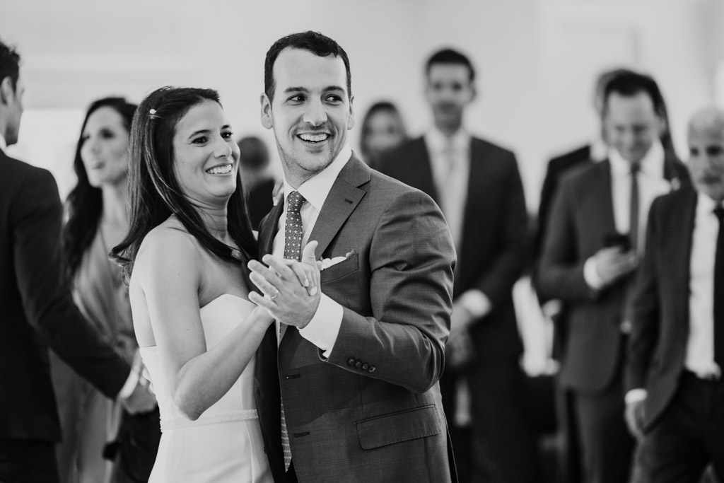 Black and white photo of bride and groom smiling while dancing together at their Être Farms wedding reception