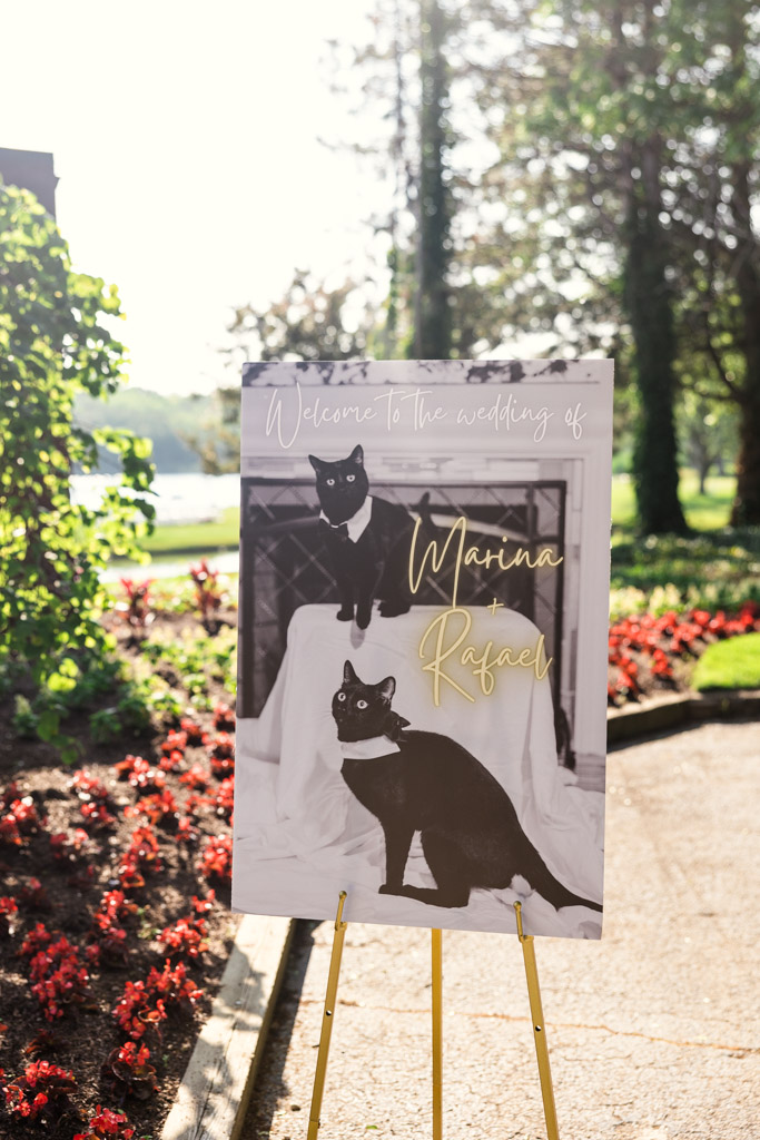 Custom wedding sign featuring newlywed couple's two black cats outside Kemper Lakes Golf Club