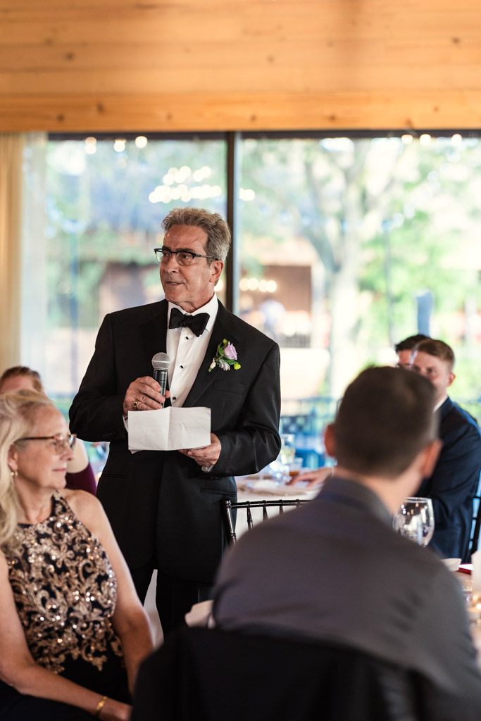 Bride's father gives a speech at Kemper Lakes Golf Club wedding reception with seated guests listening attentively