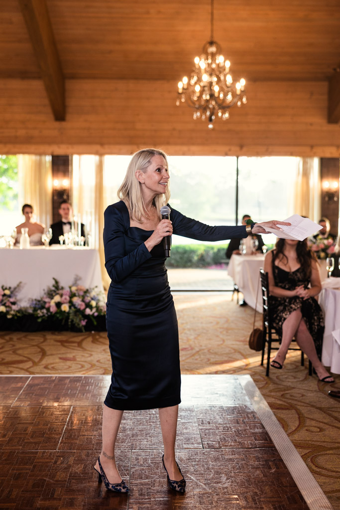 Groom's mother in a dark dress gives speech during Kemper Lakes Golf Club wedding reception