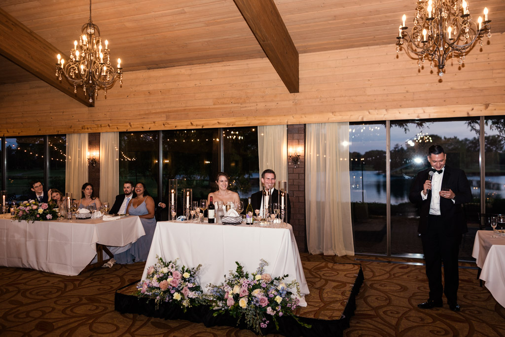 Best Man gives speech at a wedding reception at Kemper Lakes Golf Club, with the bride, groom, and guests seated at decorated tables