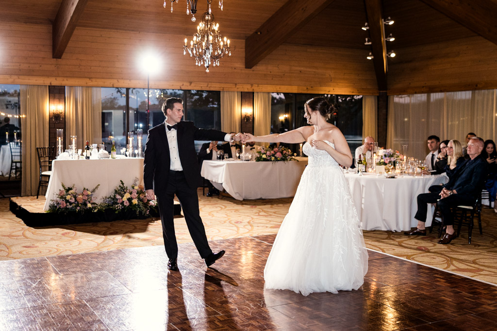 Bride and groom share their first dance in a warmly lit reception hall at Kemper Lakes Golf Club