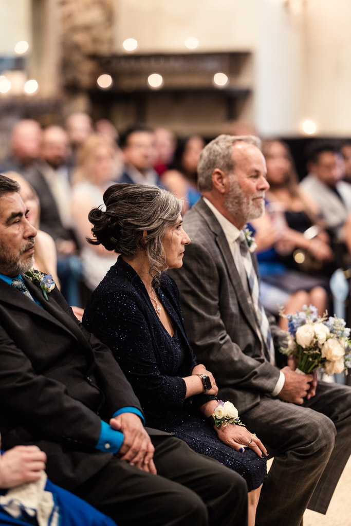 Bride's parents sit in the front row during Osteria Via Stato wedding ceremony