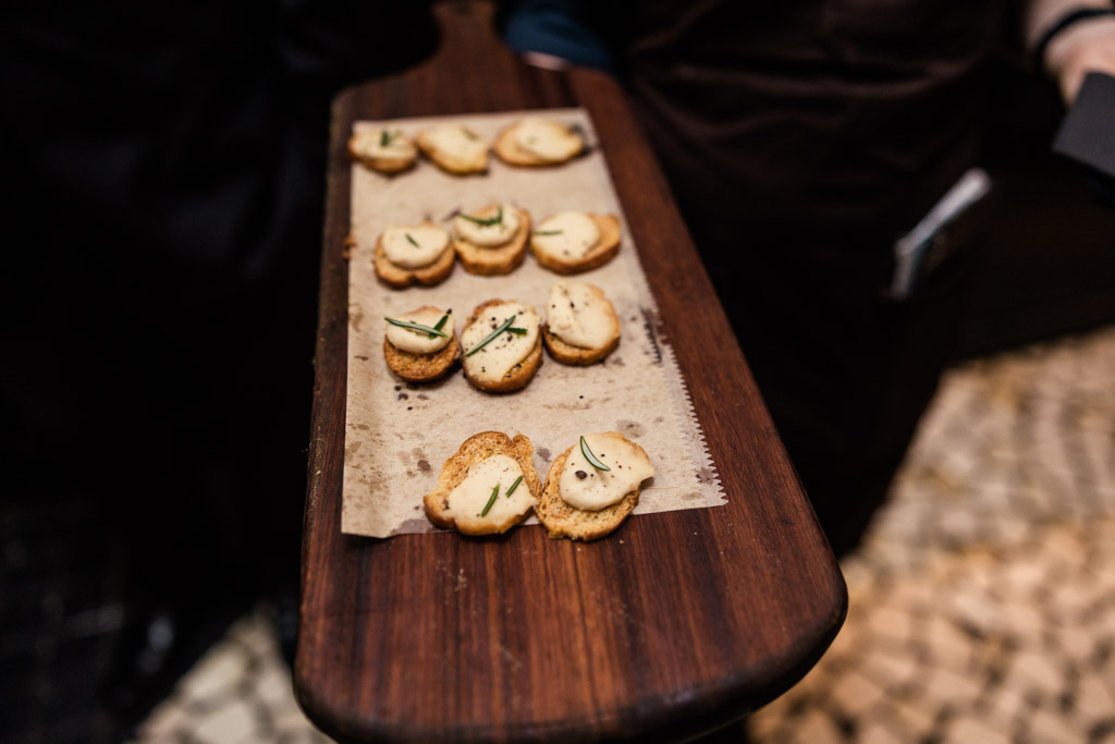 A wooden tray of appetizers for Osteria Via Stato wedding celebration