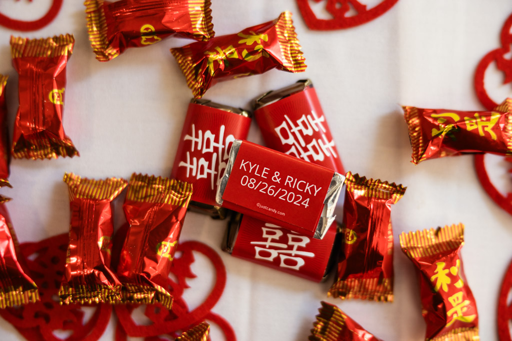 Red and gold wrapped candies for wedding reception at The Drake, with custom wrappers
