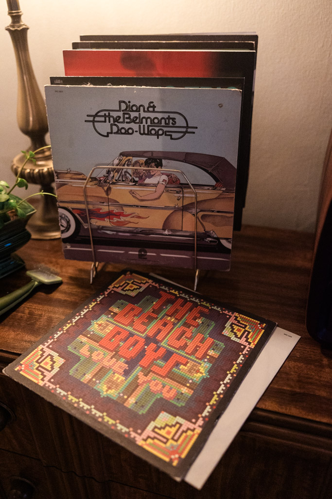A stack of vinyl records on a wooden table during Ravenswood engagement session