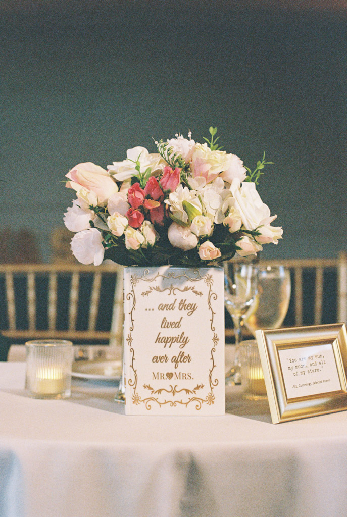 Film photo of floral centerpiece and wedding sign on sweetheart table for wedding reception at The Library at 190 in downtown Chicago