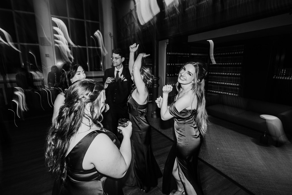 Black and white photo of guests in formal wear dancing and celebrating during wedding reception at The Library at 190 in downtown Chicago