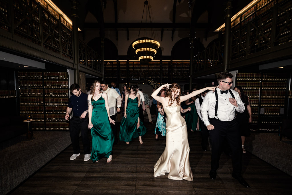 Bride, groom and guests on the dance floor during wedding reception at The Library at 190 in downtown Chicago