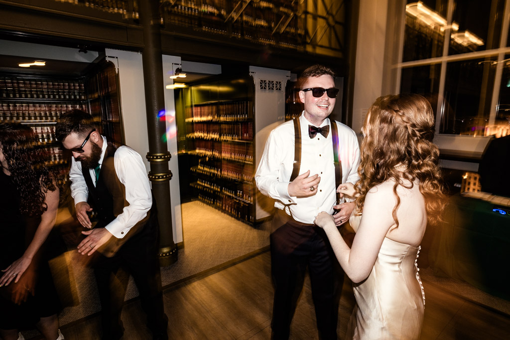 Bride and groom on the dance floor, the groom wearing sunglasses during their wedding reception at The Library at 190 in downtown Chicago