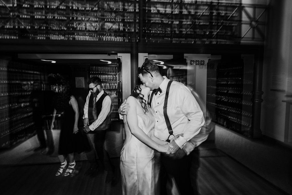 Black and white photo of newlyweds kissing while dancing during their wedding reception at The Library at 190 in downtown Chicago