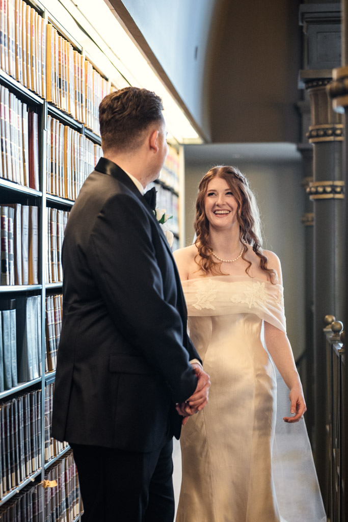 Bride and groom smile at each other during their first look on a balcony at The Library at 190 in downtown Chicago