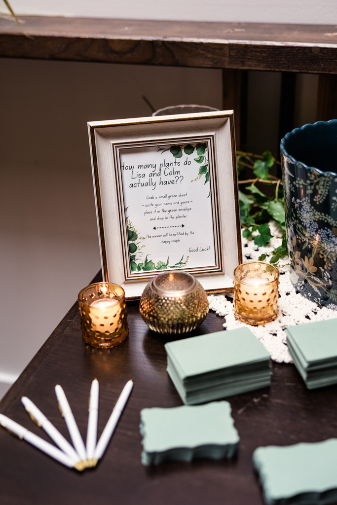 Detail photo of wedding reception card and gift table at The Arbory Chicago with candles, pens, notepads, and a framed sign