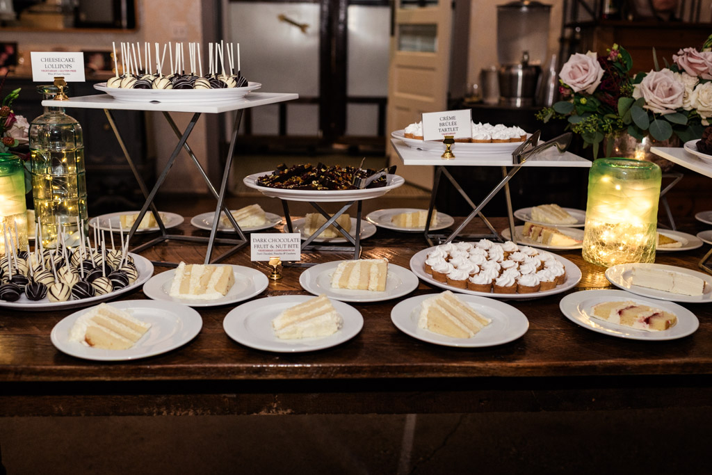 Assorted desserts and slices of cake arranged on plates and trays on dessert table at Firehouse Chicago