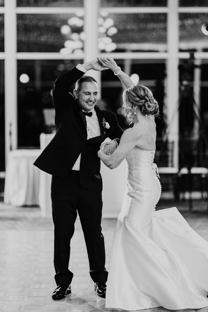 Black and white photo of bride and groom smiling as they dance together at their Lincolnshire Marriott Resort wedding reception